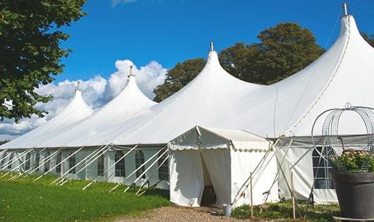 a group of luxury portable restrooms with individual stalls and running water in Milltown